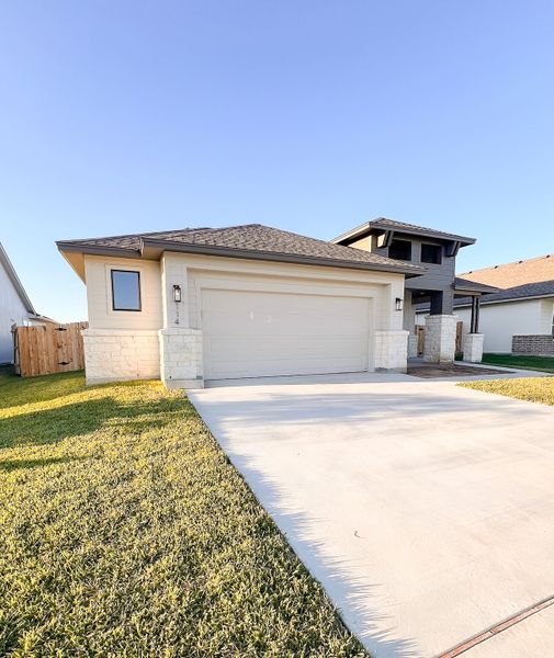 Front exterior of a new home in TerraVista, Victoria, TX, highlighting curb appeal (Image 21).