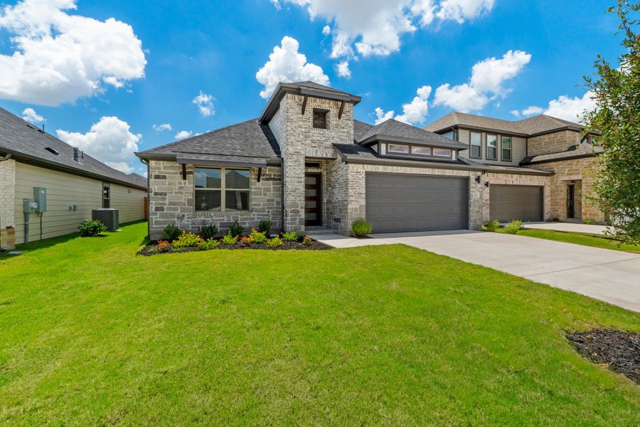 Front exterior of a new home in Prairie Winds, Hutto, TX, highlighting curb appeal (Image 23).