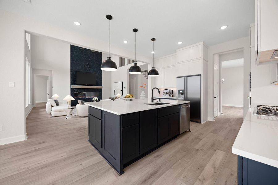 Another perspective of the gourmet kitchen, showcasing the perfect operational workflow and expansive view into the main living spaces. The view looks directly into the stunning two-story family room, emphasizing the home's seamless, open floor plan that keeps the chef fully connected to guests and family activities. *Virtually Staged Another perspective of the gourmet kitchen, showcasing the perfect operational workflow and expansive view into the main living spaces. The view looks directly into the stunning two-story family room, emphasizing the home's seamless, open floor plan that keeps the chef fully connected to guests and family activities. *Virtually Staged