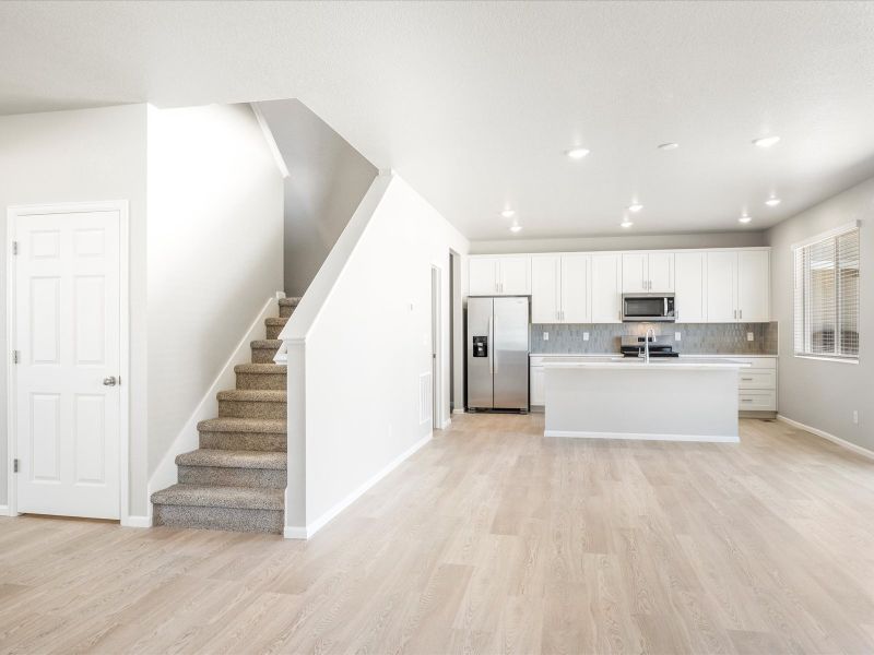 Great room in the Wateron floorplan at a Meritage Homes community in Brighton, CO.