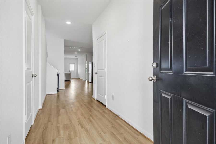 Hallway featuring light wood-style floors and recessed lighting