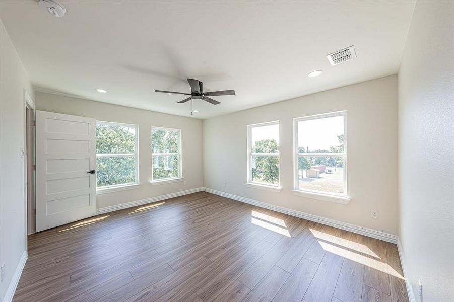 Unfurnished room featuring wood finished floors, ceiling fan, and recessed lighting Unfurnished room featuring wood finished floors, ceiling fan, and recessed lighting