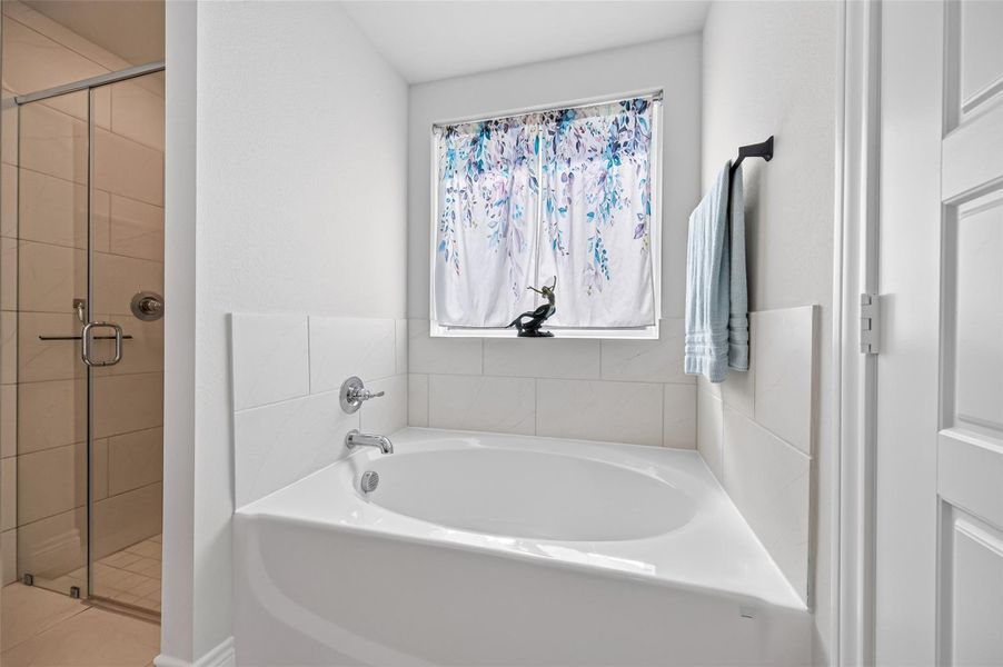 This stunning, spacious primary bathroom serves as a private retreat, featuring a luxurious deep-soaking garden tub perfect for relaxation alongside a separate, elegantly designed glass-enclosed walk-in shower. The modern layout is complemented by high-end finishes and plenty of natural light, offering a sophisticated spa-like atmosphere for daily comfort and rejuvenation. This stunning, spacious primary bathroom serves as a private retreat, featuring a luxurious deep-soaking garden tub perfect for relaxation alongside a separate, elegantly designed glass-enclosed walk-in shower. The modern layout is complemented by high-end finishes and plenty of natural light, offering a sophisticated spa-like atmosphere for daily comfort and rejuvenation.
