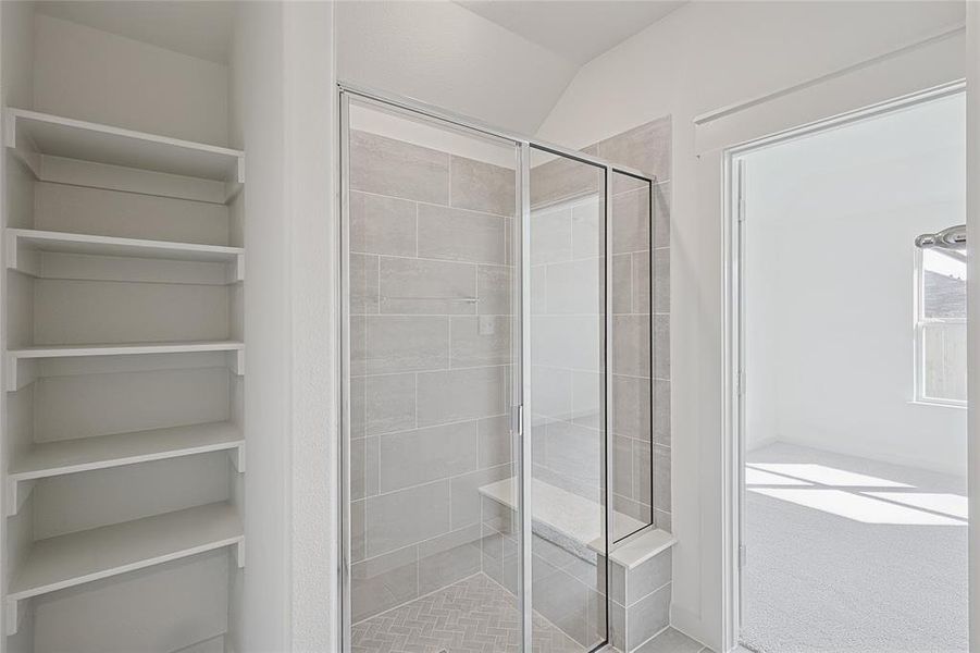 Bathroom with walk in shower and vaulted ceiling