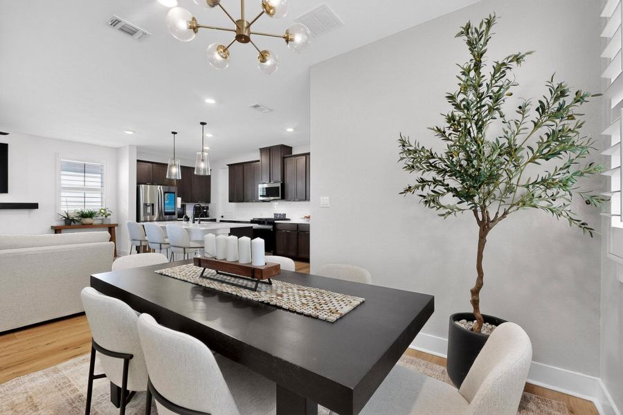 Dining area featuring light wood-style floors, a chandelier, and recessed lighting