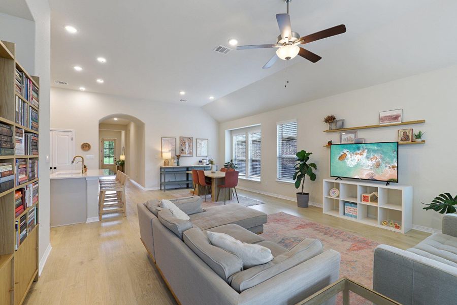 Natural light illuminates an inviting living area with a vaulted ceiling and sleek flooring.