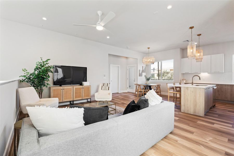 The living room flows seamlessly into the dining and kitchen spaces, making it easy to host without feeling segmented.