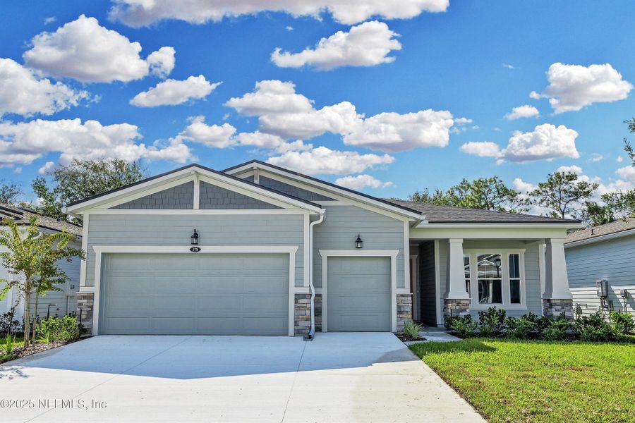Front exterior of a new home in RiverTown - WaterSong, St. Johns, FL, highlighting curb appeal (Image 12). Front exterior of a new home in RiverTown - WaterSong, St. Johns, FL, highlighting curb appeal (Image 12).
