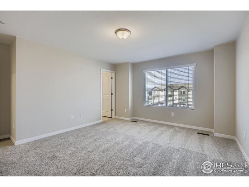 The spacious primary bedroom