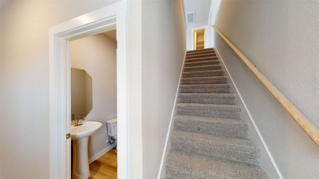 Stairs featuring wood finished floors