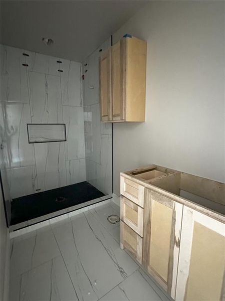 Secondary bathroom with tiled shower