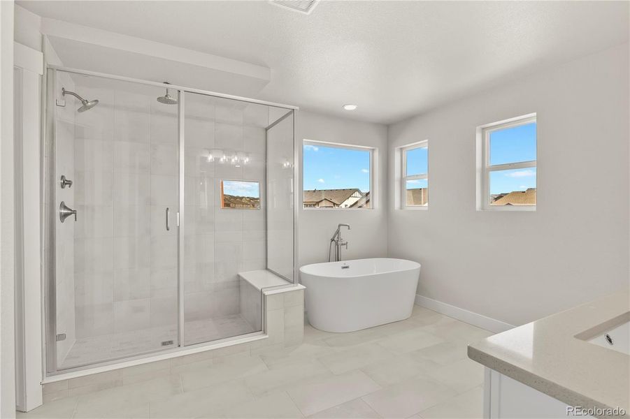 Five-piece bath finished with soaker tub and large shower with bench