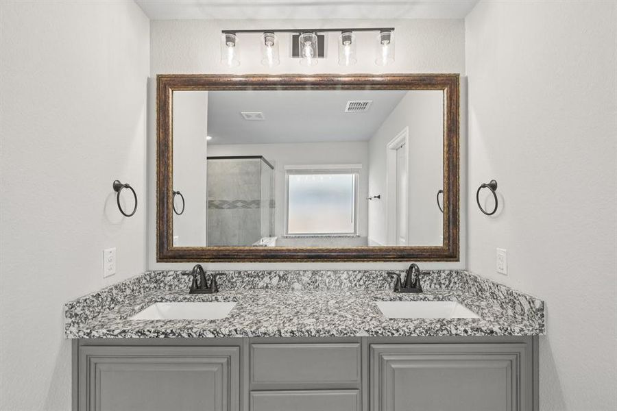Bathroom with double vanity and a stall shower Bathroom with double vanity and a stall shower