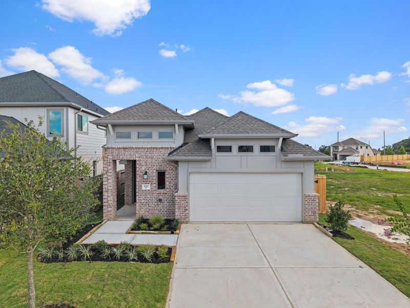 Front exterior of a new home in Candela, Richmond, TX, highlighting curb appeal (Image 21). Front exterior of a new home in Candela, Richmond, TX, highlighting curb appeal (Image 21).