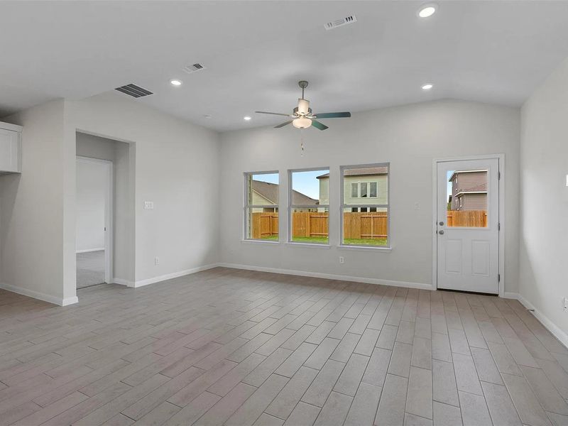 Natural light floods this living area, highlighting the contemporary tile flooring and views to a private yard.