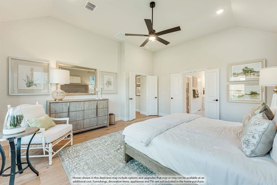 Spacious master bedroom with high ceilings, ceiling fan, hardwood floors, and neutral decor with dresser and seating area