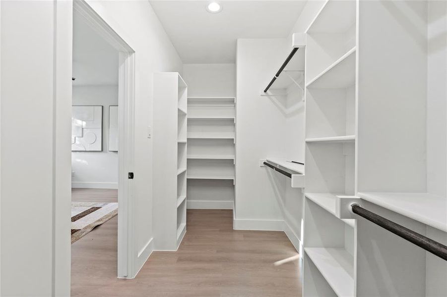 Walk in closet featuring light wood-style floors