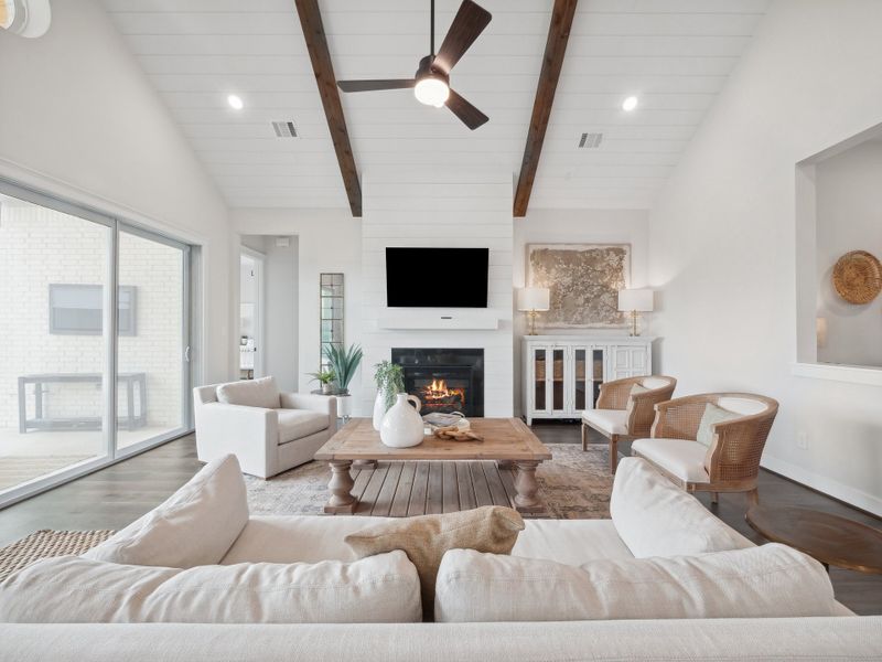 Great room with fireplace and stained ceiling beams Great room with fireplace and stained ceiling beams