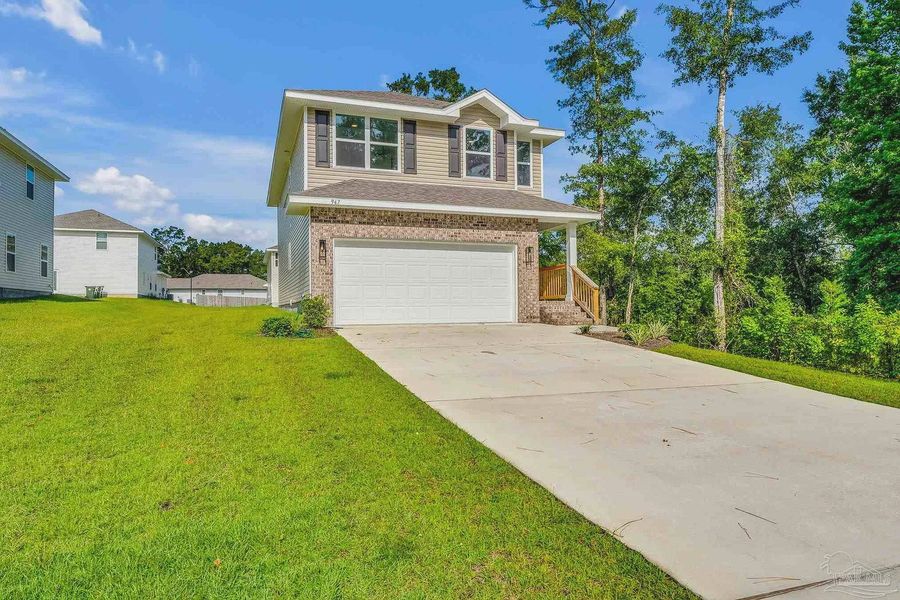 Front exterior of a new home in Pine Top, Cantonment, FL, highlighting curb appeal (Image 14). Front exterior of a new home in Pine Top, Cantonment, FL, highlighting curb appeal (Image 14).