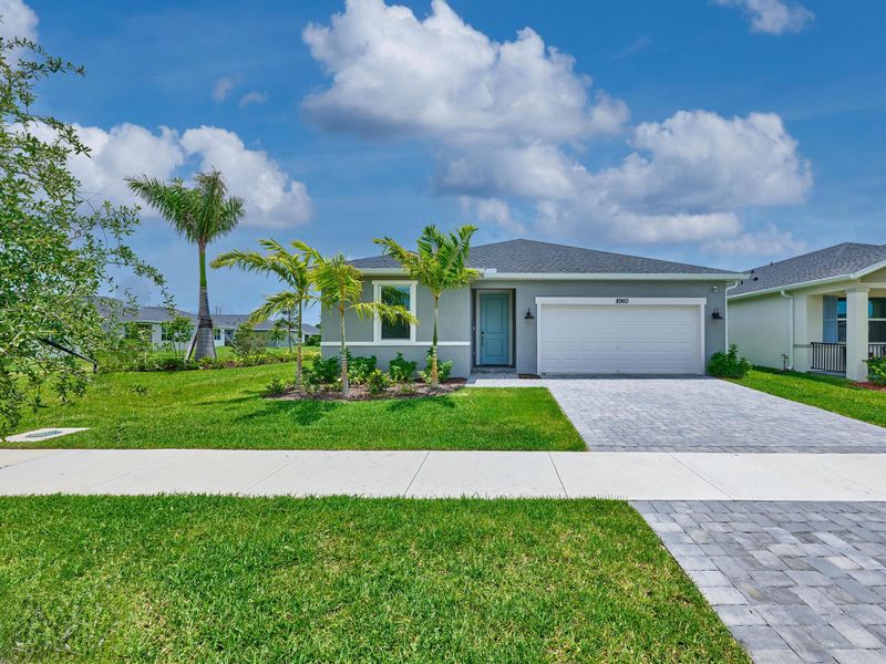 Front exterior of a new home in Azalea, Port St. Lucie, FL, highlighting curb appeal (Image 1).