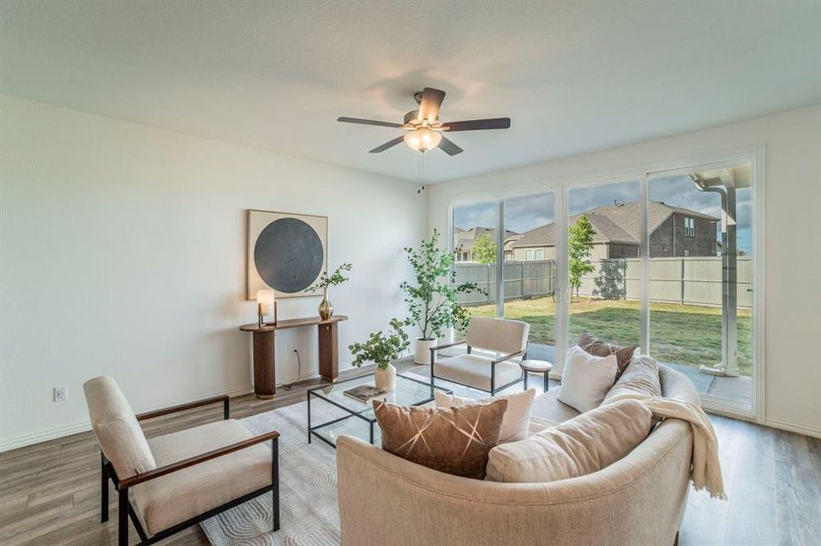 Living area featuring light wood-type flooring and ceiling fan Living area featuring light wood-type flooring and ceiling fan