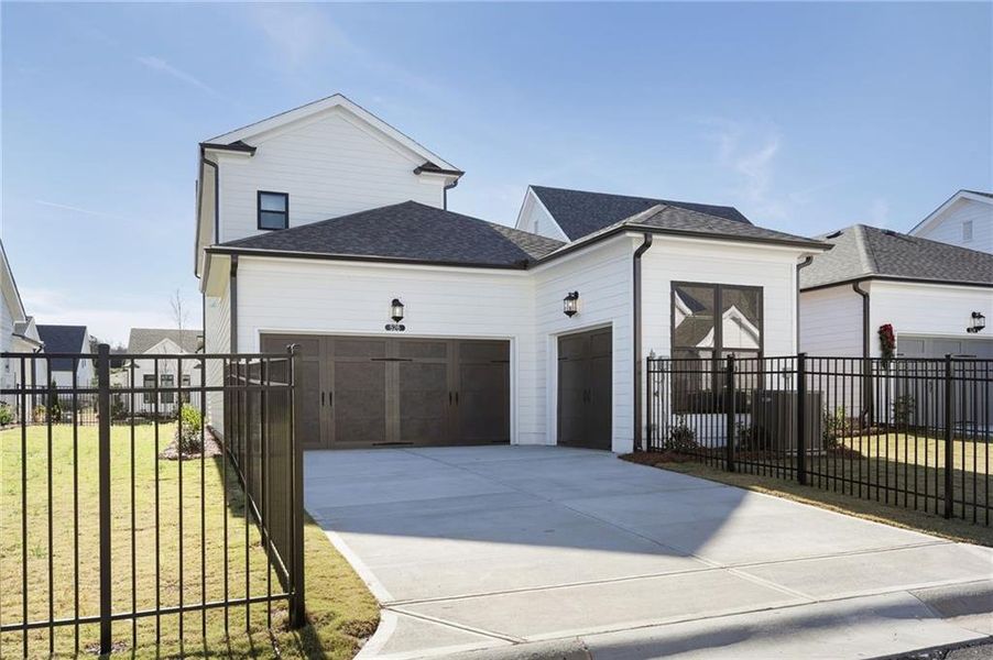 Front exterior of a new home in Promenade at Sawnee Village, Cumming, GA, highlighting curb appeal (Image 26). Front exterior of a new home in Promenade at Sawnee Village, Cumming, GA, highlighting curb appeal (Image 26).