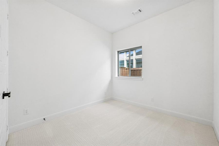 Unfurnished room with light carpet and baseboards Unfurnished room with light carpet and baseboards