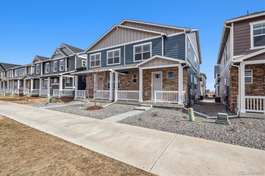 Front exterior of a new home in Horizon Uptown, Aurora, CO, highlighting curb appeal (Image 2).