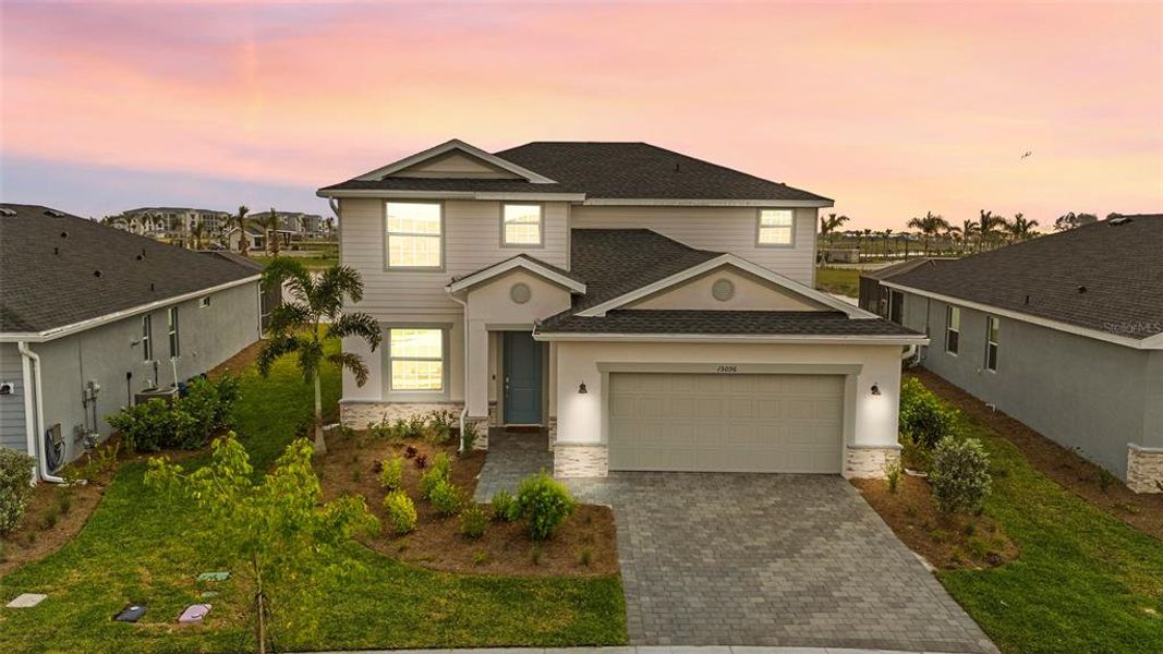 Front exterior of a new home in Tuckers Cove: Villas, Punta Gorda, FL, highlighting curb appeal (Image 1).