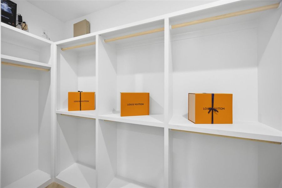 Spacious walk-in primary closet Spacious walk-in primary closet