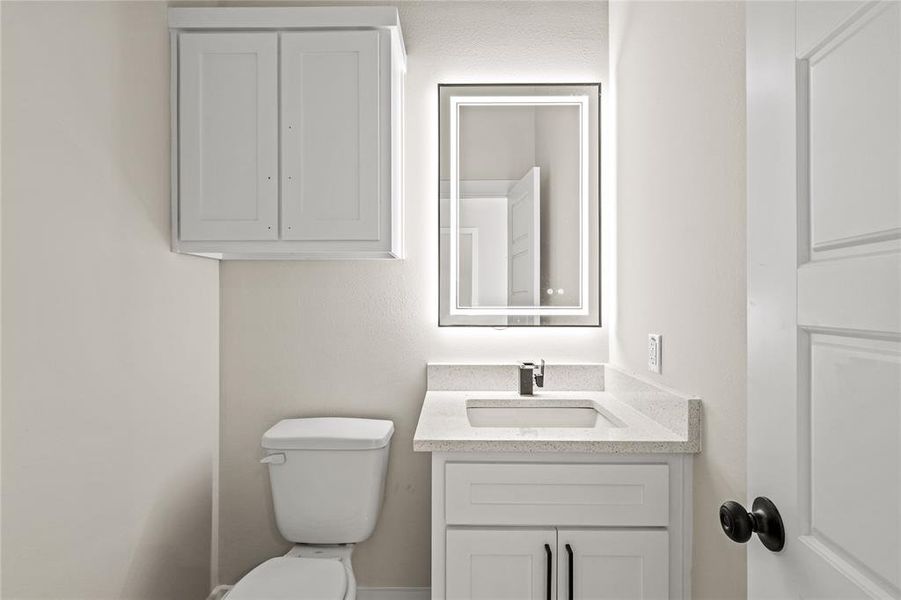 Bathroom with vanity and toilet