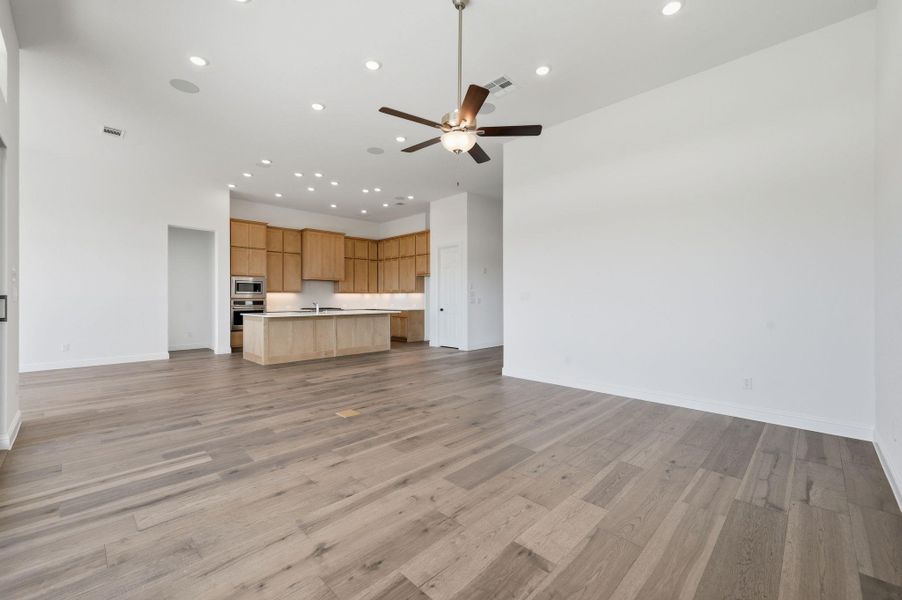 Unfurnished living room with light wood-style floors, recessed lighting, and a ceiling fan