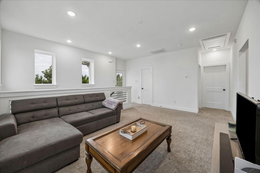 The game room landing serves as a versatile secondary living space and central hub connecting the bedrooms and utility room, offering a comfortable and functional gathering area upstairs.