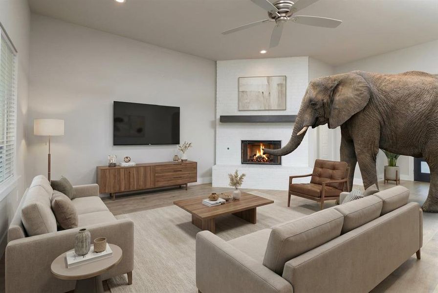 As for the elephant in the room… well, at least here it’s literal. The good news is this space is so large it actually can handle most furniture. He seems to have taken over fireplace duty and looks like he’s warming his trunk. Hopefully he’s house-trained and doesn’t expect peanuts with the mortgage. ???? (Staged) As for the elephant in the room… well, at least here it’s literal. The good news is this space is so large it actually can handle most furniture. He seems to have taken over fireplace duty and looks like he’s warming his trunk. Hopefully he’s house-trained and doesn’t expect peanuts with the mortgage. ???? (Staged)