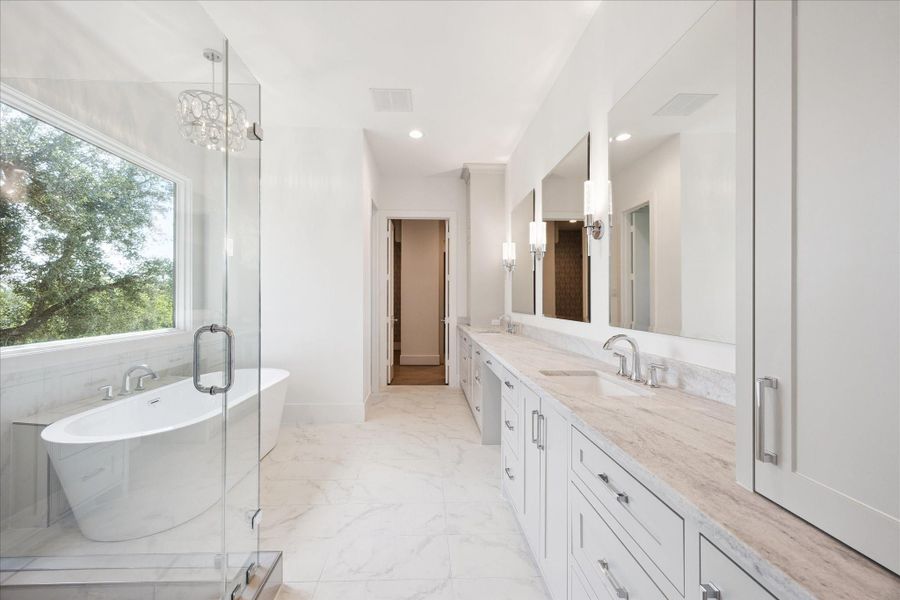 Primary bath is a true retreat with a large glass shower with upscale tile and separate freestanding soaking tub. Dual vanity areas and sinks, private water closet, storage and a boutique-style walk in closet. Primary bath is a true retreat with a large glass shower with upscale tile and separate freestanding soaking tub. Dual vanity areas and sinks, private water closet, storage and a boutique-style walk in closet.