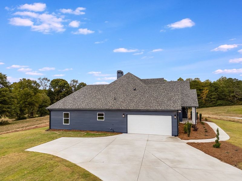 Front exterior of a new home in Parmer Farms, Roopville, GA, highlighting curb appeal (Image 2).