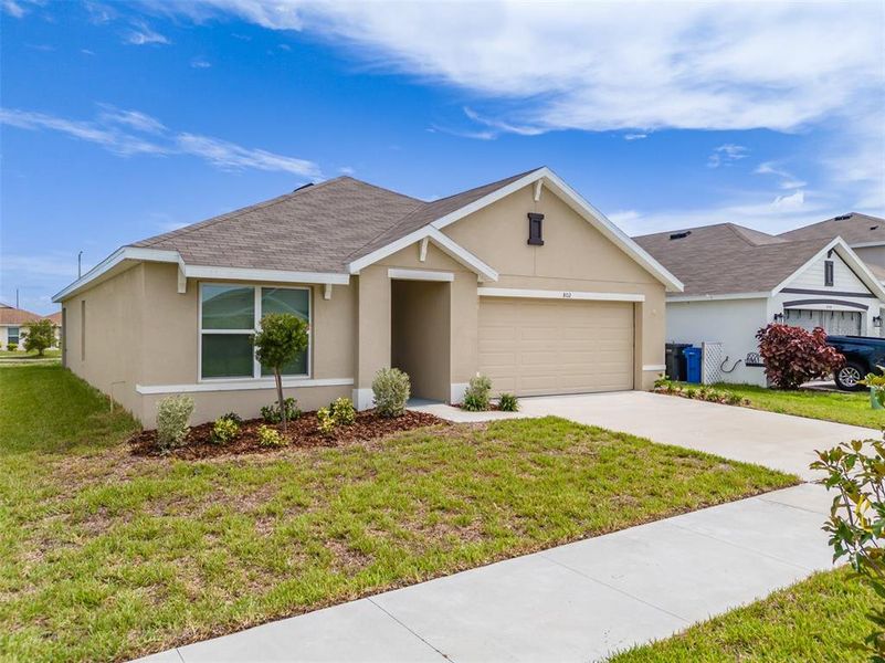 Front exterior of a new home in Brookside, Ruskin, FL, highlighting curb appeal (Image 23). Front exterior of a new home in Brookside, Ruskin, FL, highlighting curb appeal (Image 23).