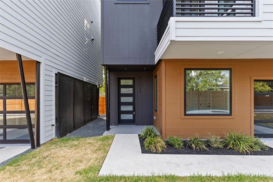 Modern architectural lines and mixed siding textures frame the welcoming, recessed entryway.