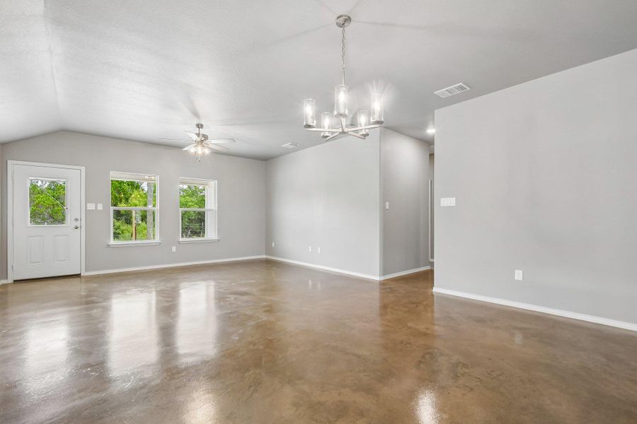 A spacious, airy living area features sleek concrete flooring and abundant natural light. A spacious, airy living area features sleek concrete flooring and abundant natural light.