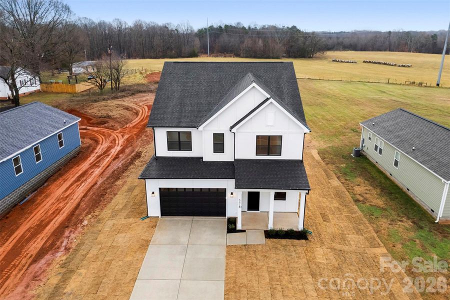 Front exterior of a new home in , Troutman, NC, highlighting curb appeal (Image 27).