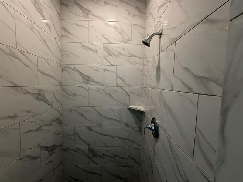 along with bath tub there is a standing bath