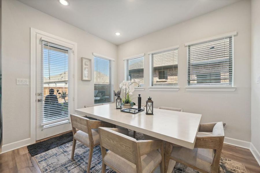 Dining room with dark hardwood / wood-style flooring