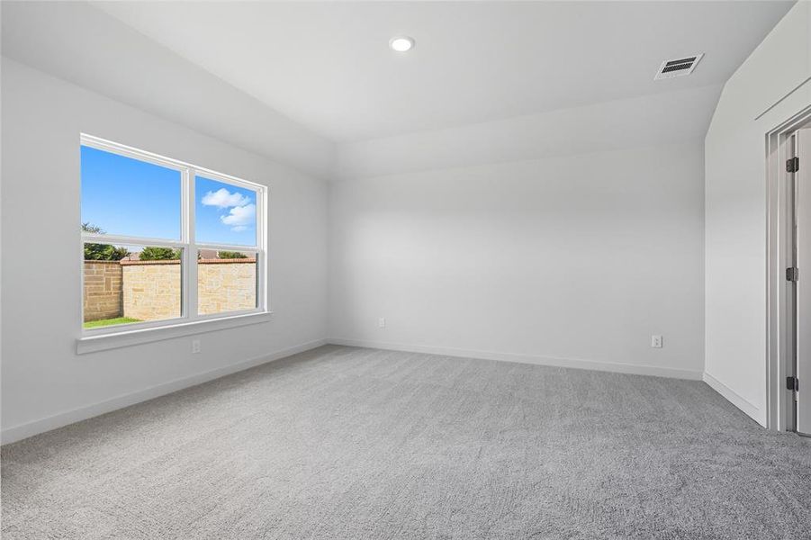 Spare room featuring light colored carpet and recessed lighting