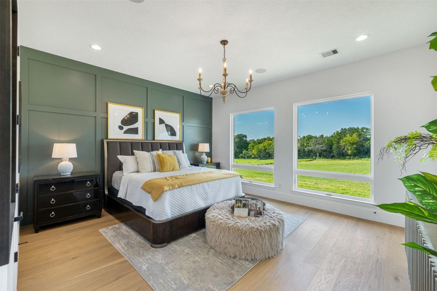 Bedroom with a decorative wall, a chandelier, light wood-style flooring, and recessed lighting