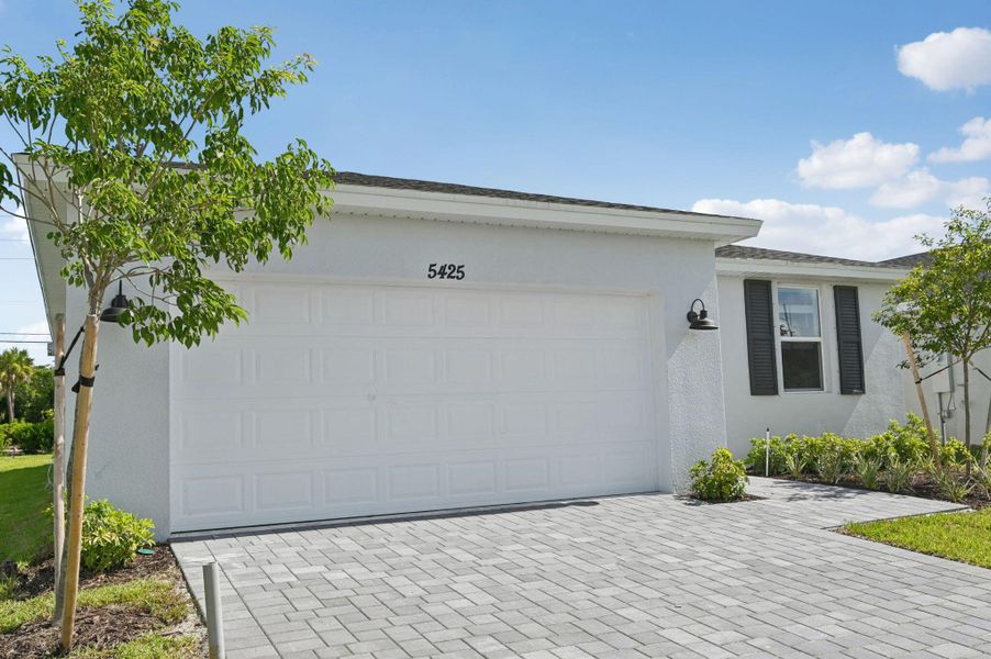 Front exterior of a new home in Hampton Park - Classic Series, Vero Beach, FL, highlighting curb appeal (Image 18). Front exterior of a new home in Hampton Park - Classic Series, Vero Beach, FL, highlighting curb appeal (Image 18).