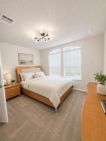 Room featuring arched windows with blinds, a contemporary ceiling light fixture, and neutral carpeting