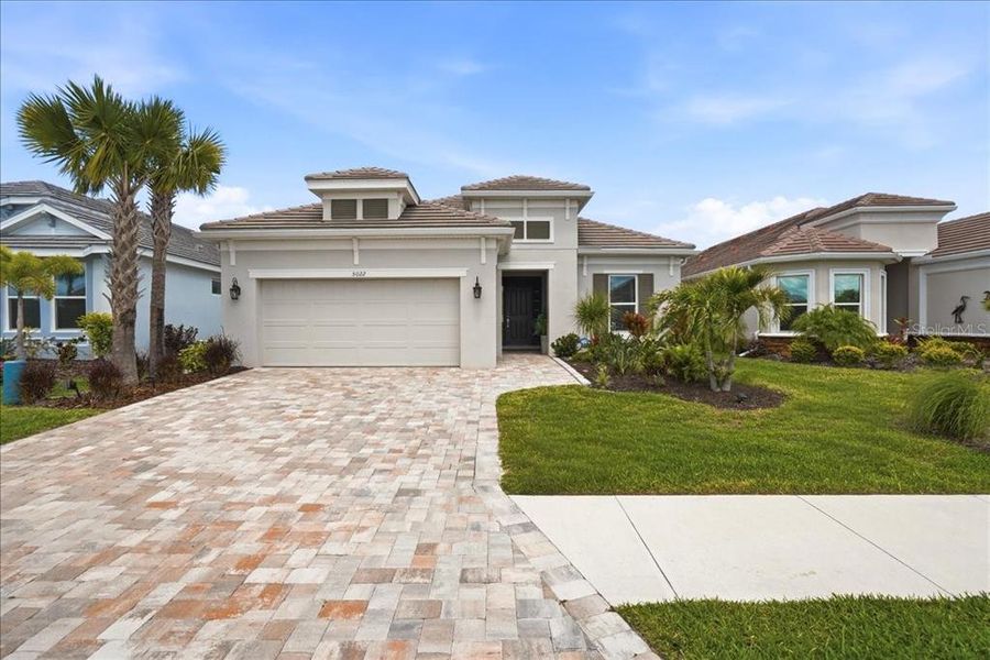 Front exterior of a new home in Esplanade at Artisan Lakes, Palmetto, FL, highlighting curb appeal (Image 21).