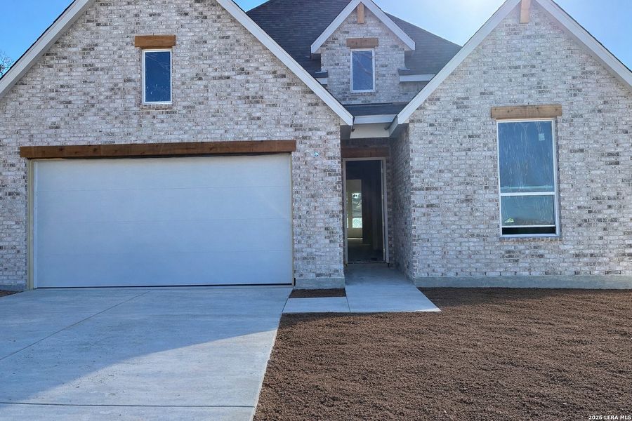 Front exterior of a new home in The Ranches at Creekside, Boerne, TX, highlighting curb appeal (Image 1). Front exterior of a new home in The Ranches at Creekside, Boerne, TX, highlighting curb appeal (Image 1).