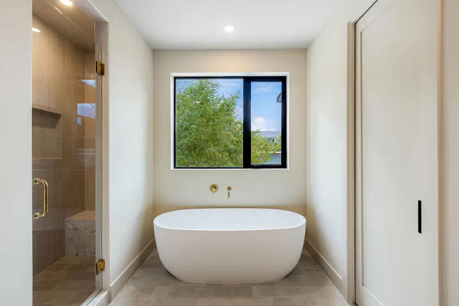 Full bath with a freestanding bath, a stall shower, and recessed lighting Full bath with a freestanding bath, a stall shower, and recessed lighting