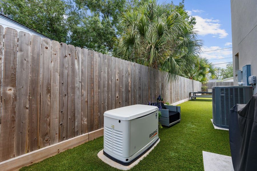 A whole-home generator adds everyday peace of mind, with turf extending along the side yard for a clean, low-maintence outdoor space.